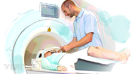 MRI tech helping patient through MRI
