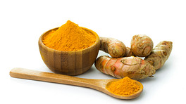 Turmeric root and powder in a bowl