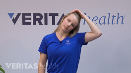 Woman doing a lateral neck flexion.
