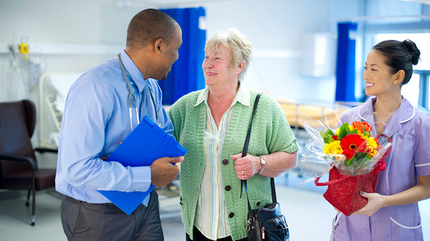 A woman talking with a doctor in a hospital setting