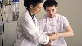 Doctor examining patients hand