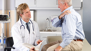 Doctor and patient having a discussion in an office.