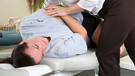 Chiropractor manipulating a patient&#039;s lower back