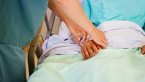 A nurse adjusting a patient IV