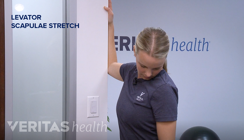 Therapist showing levator scapulae stretch.