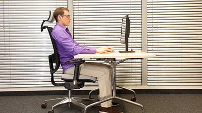 Man sitting ergonomically correct in his office chair.