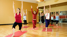 Yoga class doing warrior 1 yoga pose