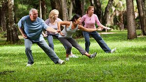 Group of people outdoors practicing Tai Chi.