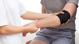 Doctor examining a patient&#039;s elbow pain.