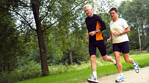 Senior couple running in the park
