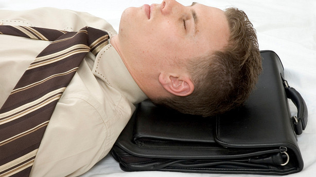 Man asleep on his briefcase