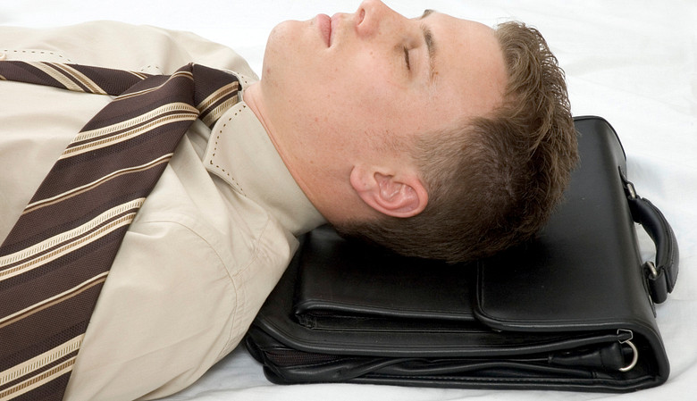 Man asleep on his briefcase