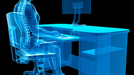 X-ray of person sitting at desk with proper posture