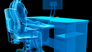 X-ray of person sitting at desk with proper posture