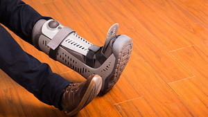 Foot with walking boot to protect the ankle.