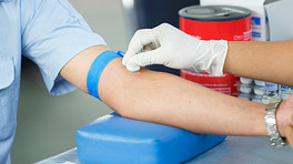 Arm being cleaned with a cotton ball for a blood test