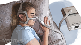Woman sleeping with a CPAP on.