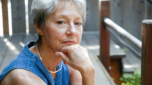Elderly woman looking thoughtfully at the camera