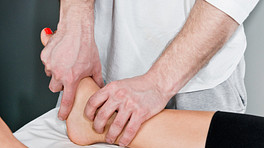 Practitioner manipulating a patient&#039;s foot and ankle.