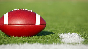 Football resting on the football field