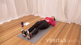 Woman lying on her back performing a piriformis muscle stretch