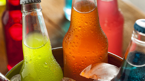 Bottles of soda on ice.