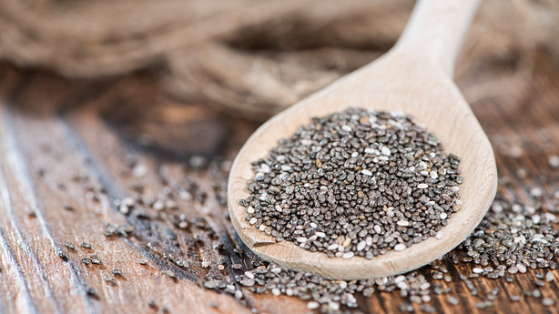 Wooden spoon full of chia seeds.