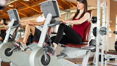 Woman riding a stationary bike at a gym