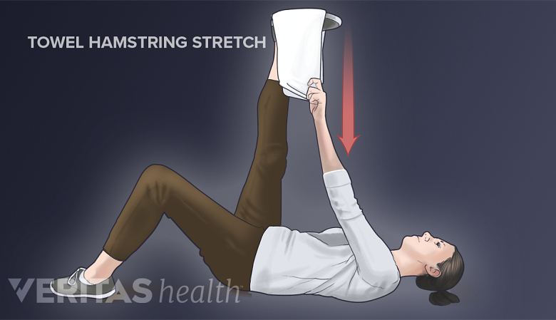 Hamstring stretch performed using a towel.