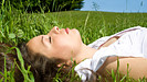 Woman lying down and resting in the grass