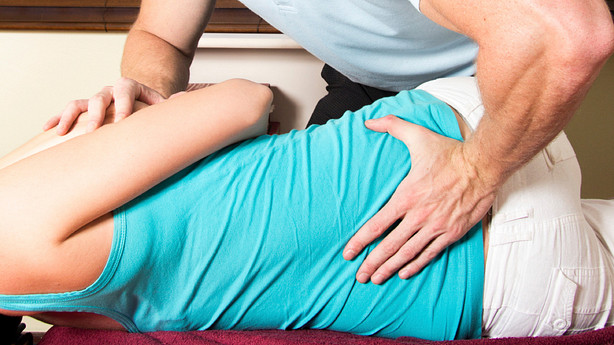 Manual manipulation performed by a chiropractor.