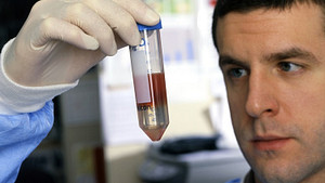 Scientist holding liquid test tube