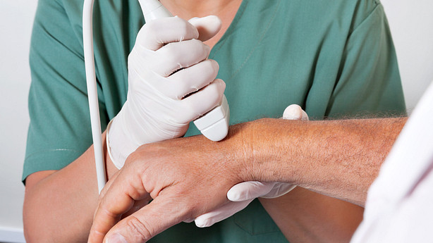 Medical technician performing an ultrasound on a wrist