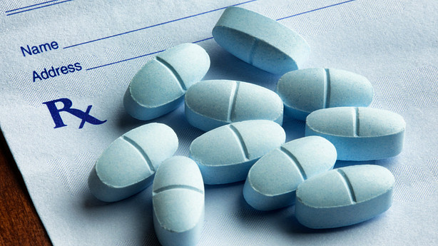 Prescription pad with blue pills.