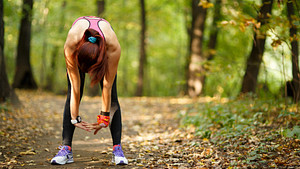 Exhausted runner stopped on a running trail.