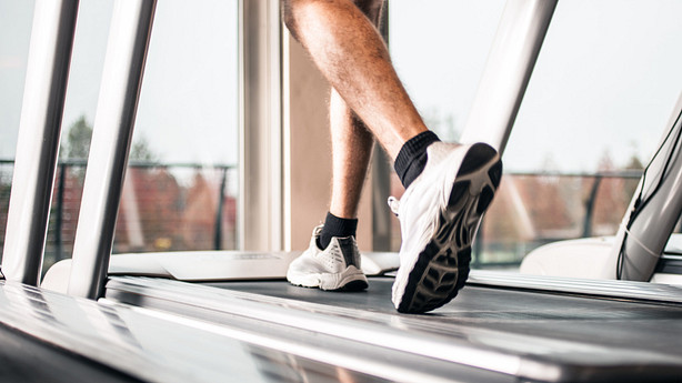 Feet running on a treadmill.