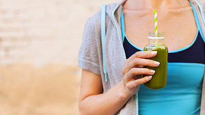 Woman drinking a green smoothie.