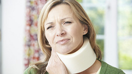 Woman with neck pain wearing a neck brace