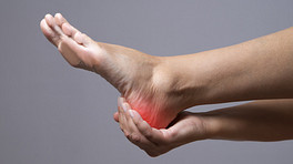Hand cradling heel with pain