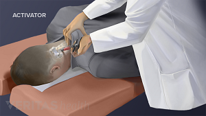 Doctor performing activator method on patient