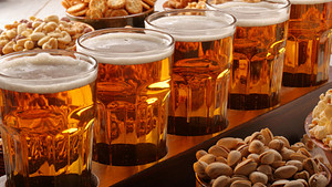 A flight of beer steins and peanuts