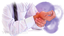 Person holding painful wrist