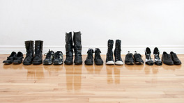 Line of shoes on a hardwood floor.