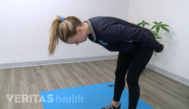 McKenzie method back exercise flexion in standing or beding forward.