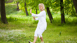 Woman in the park doing tai chi