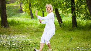 Woman in the park doing tai chi