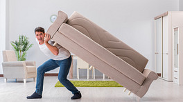 Man lifting a couch on his back