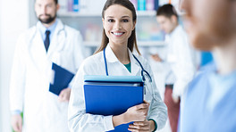 Medical professionals standing holding clipboards
