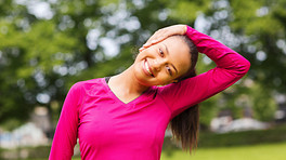 Woman stretching neck in the park