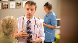 Doctor speaking to woman in his office